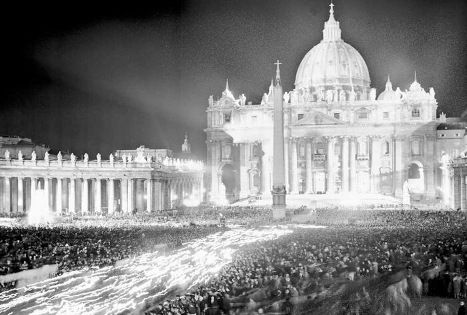 A partly aerial view of St. Peter's Square in Rome is seen at nighttime with throngs of people, many holding torches, the evening of Oct. 11, 1962.
